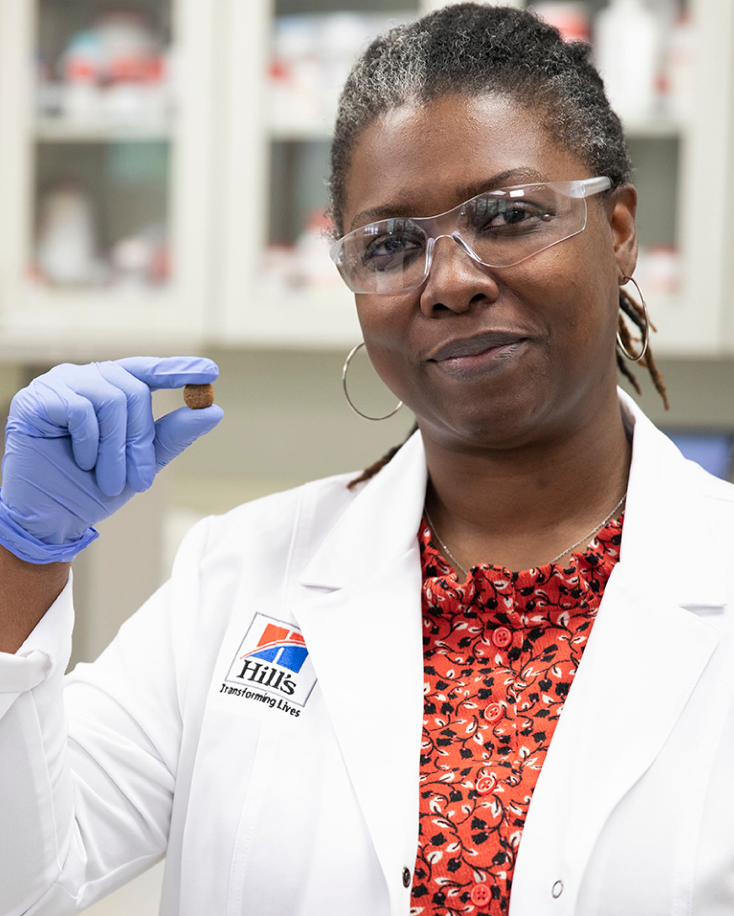 Hill's Pet Nutrition researcher holds Hill's Pet food in her hand.